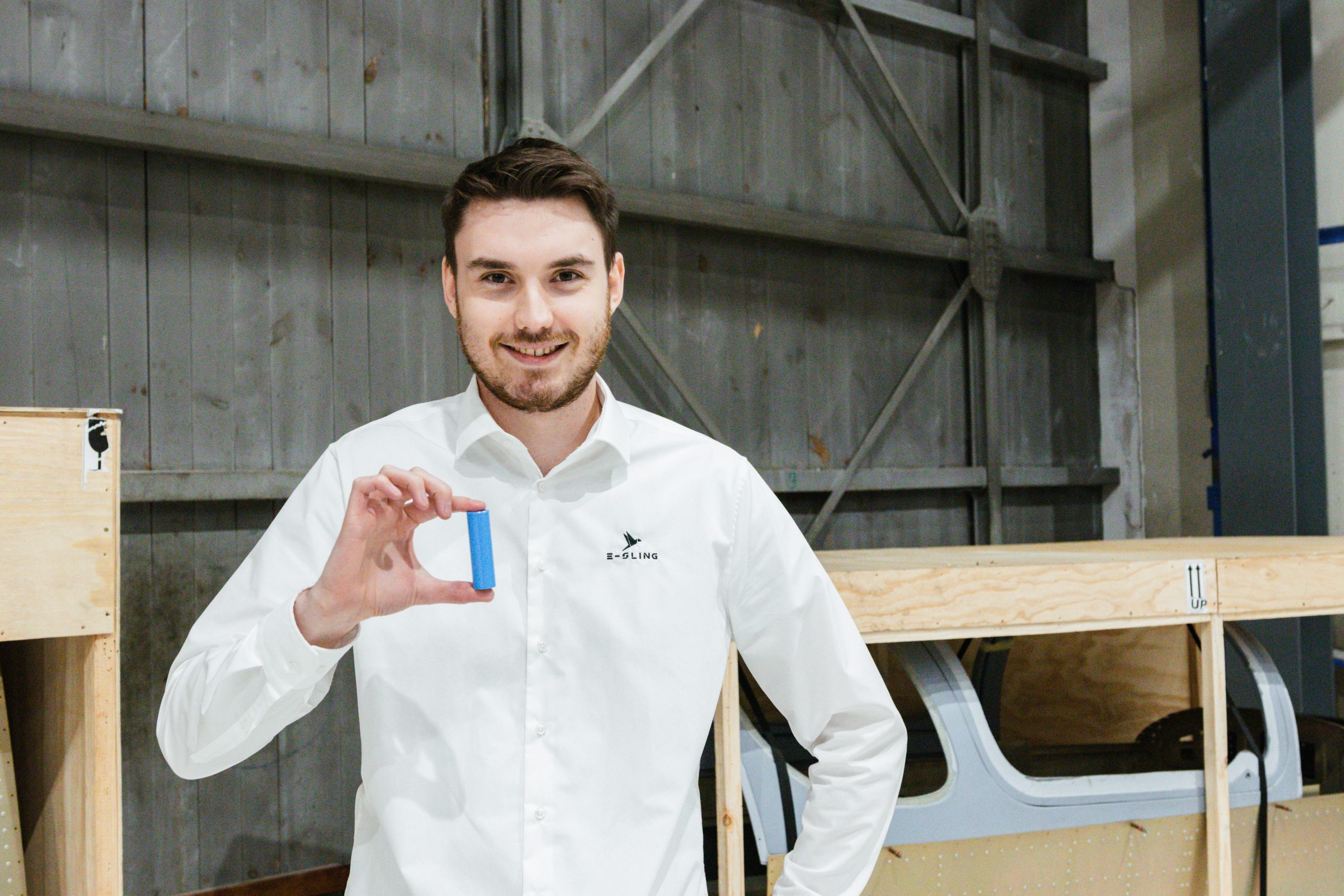 boy with a battery cell for an electronic airplane